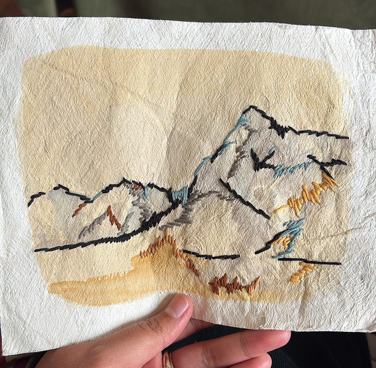 An embroidered and painted sketch of the Scottish landscape on hiapo