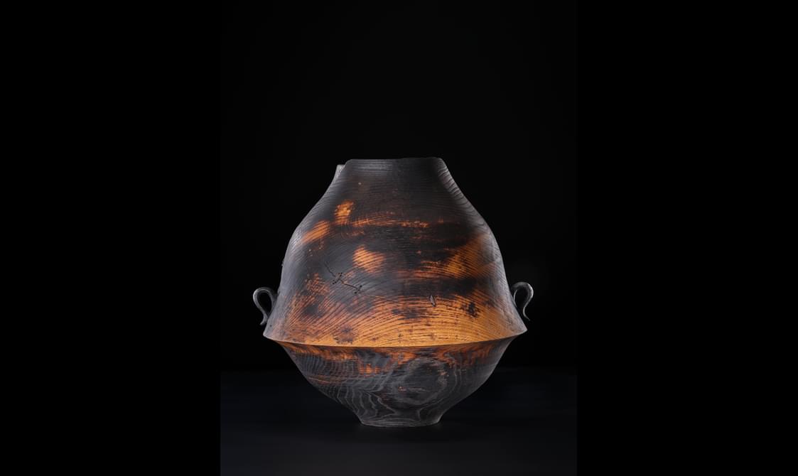 Timber oak carved into a bowl shape with 2 side handles.