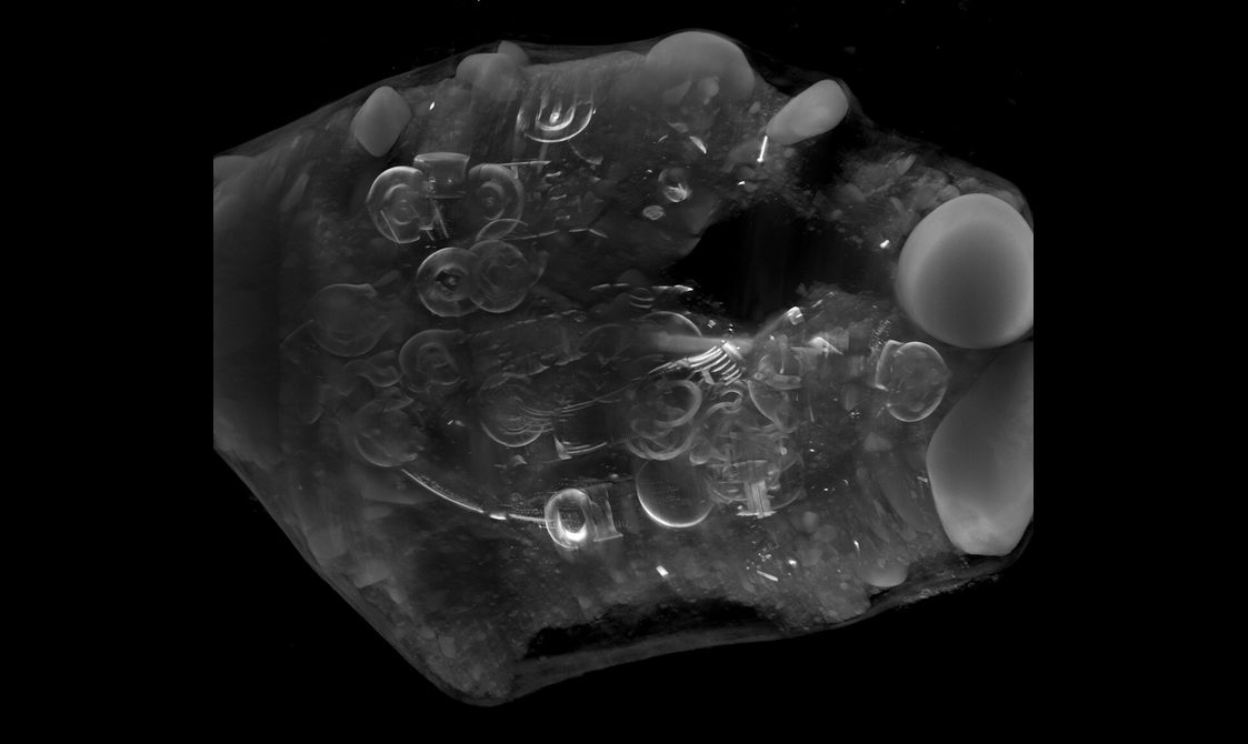 A black and white CT scan of the hoard, showing the layout of the several hundred objects within