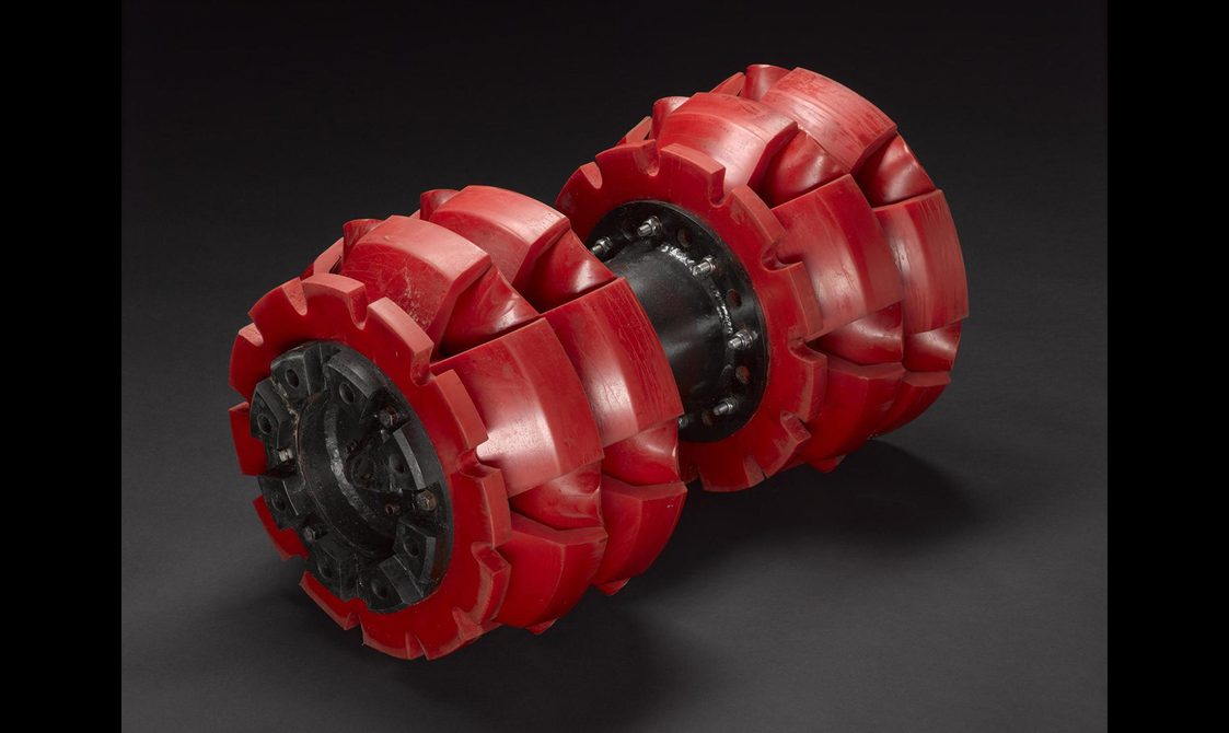 A cylindrical pipe with red coverings.