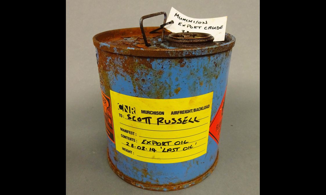 Blue canister of crude oil that reads "Scott Russell".