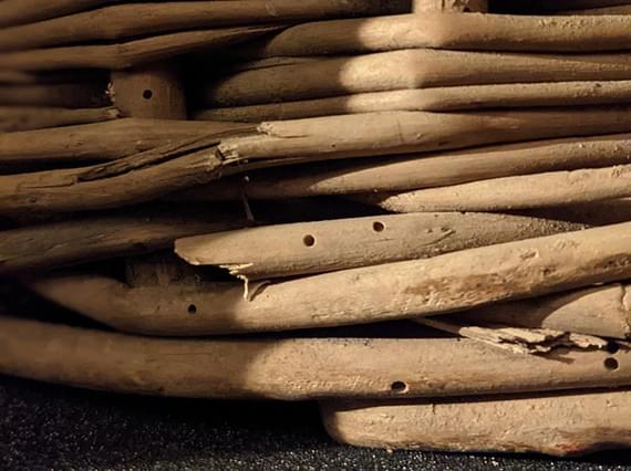 Close up of a damaged wooden basket.