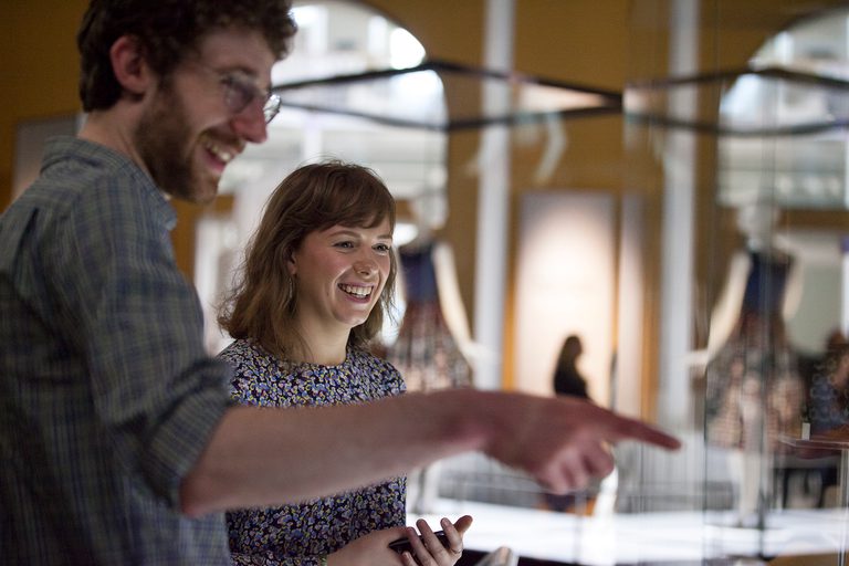 Two visitors observing a display in the museum.