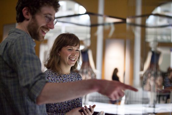 Two visitors observing a display in the museum.