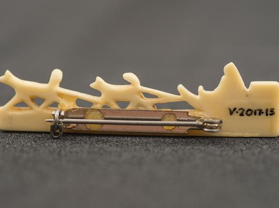 Close up of a written museum reference on an object.