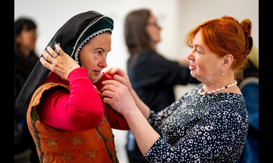 A visitor trying on a headress from the Scottish renaissance period as part of a Welcome to Scotland tour.