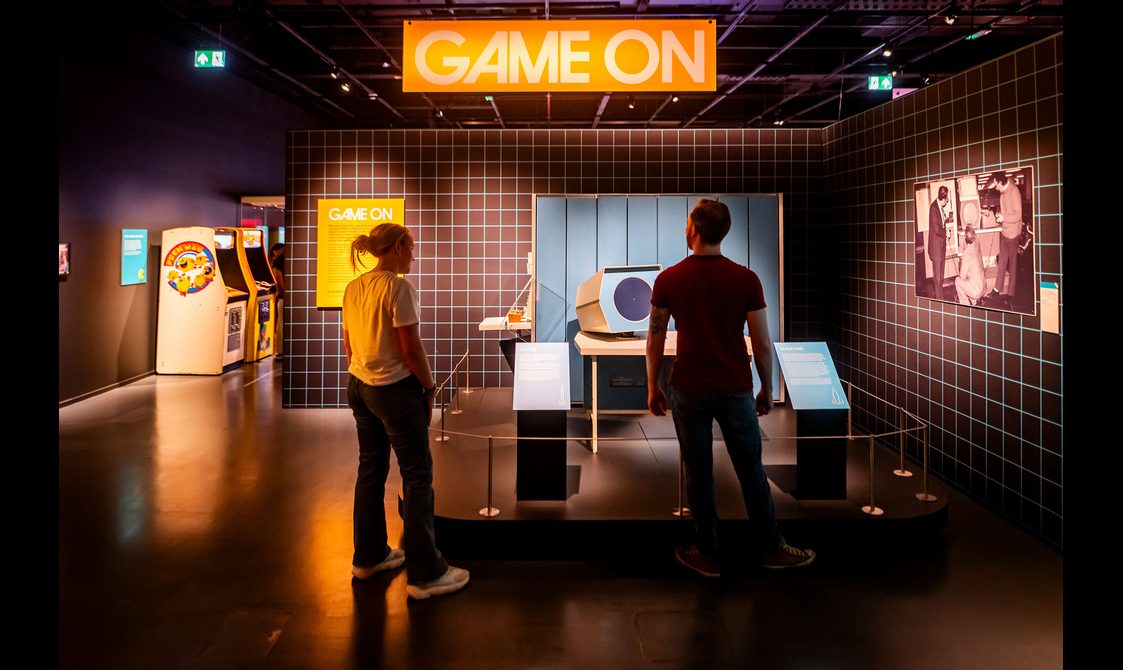 Two visitors stand at the entrance to the Game On exhibition