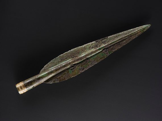 A Bronze Age spearhead. The base of the spearhead has a delicate gold hatched design.