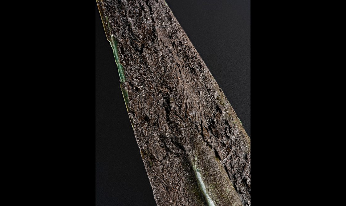 Close up of the spear showing remnants of organic material - a woolen cloth - on the shaft