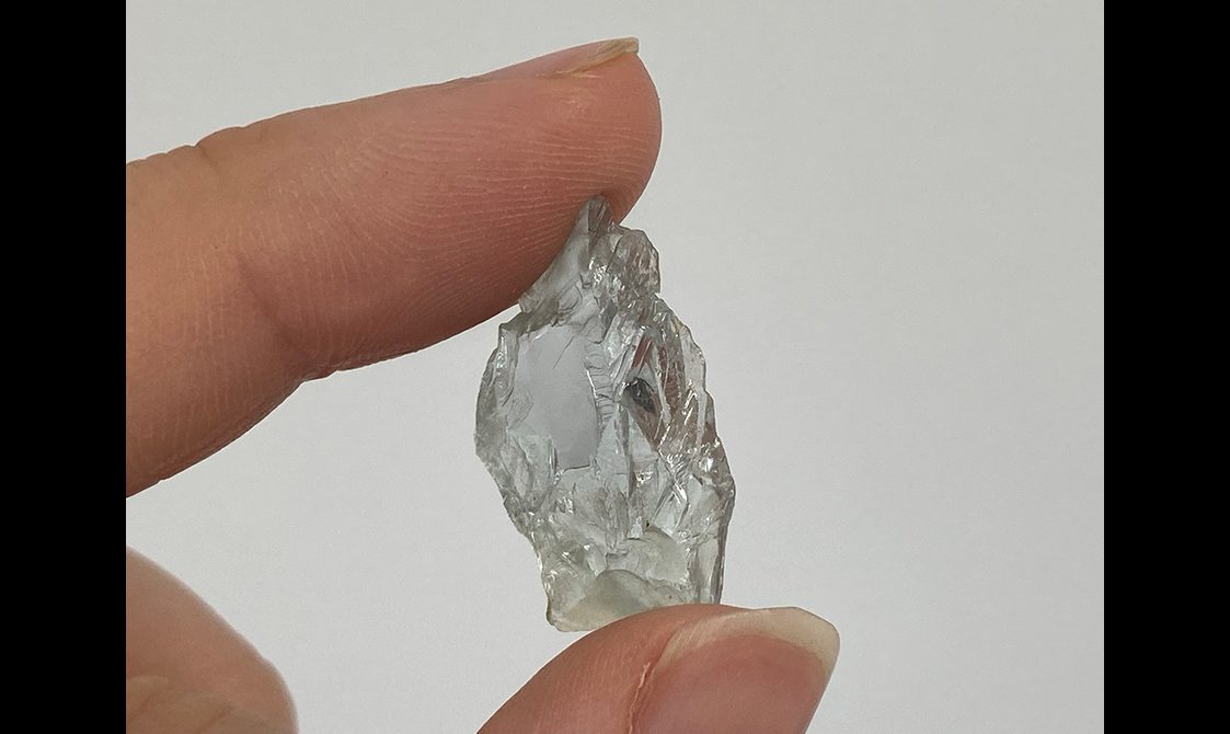 A small fragment of unfaceted clear topaz gem