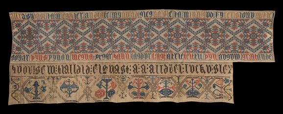 A segment of embroidered material featuring Icelandic writing