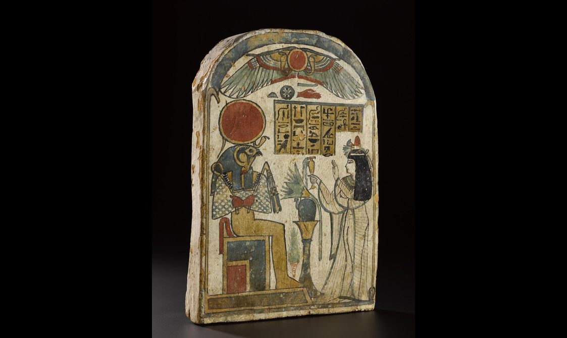 Block of wood decorated with Egyptian hieroglyphics.