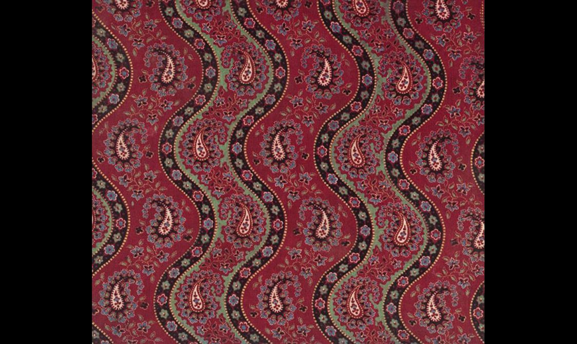 Vibrant red fabric separated into five section with black color background and floral motif waves. The golden leaf motifs set against red color background.