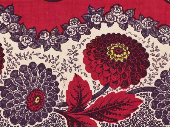 Four alternating red and black flowers with leafs set against wavy white background. Black floral motifs separate white and red backgrounds.