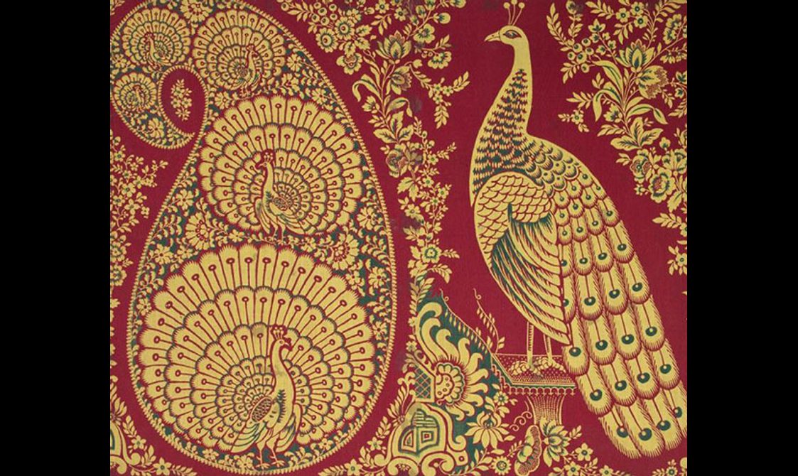 Golden peacocks in a paisley shape and large peacock to the right set against red background