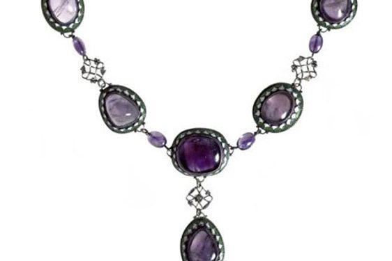 Art Deco style necklace with five purple coloured gemss set in oval green and white enamel settings arranged in a V shape. One gem in a shape of a drop is set off the five gems.