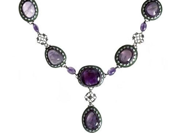 Art Deco style necklace with five purple coloured gemss set in oval green and white enamel settings arranged in a V shape. One gem in a shape of a drop is set off the five gems.