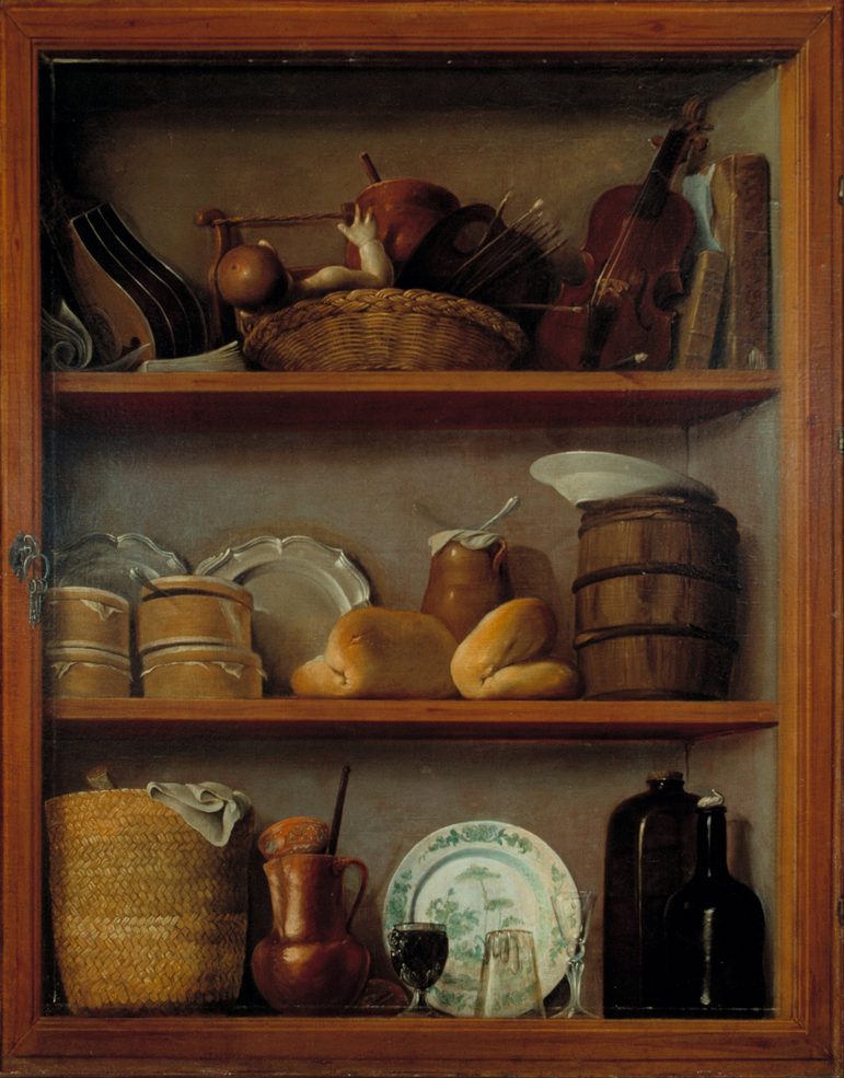 An oil painting of a 3 shelf cupboard full of different objects. The top shelf has a violin, and other musical instruments and a doll in a basket. `the middle shelf has bread and tubs with other food items. `the bottom shelf has a basket, clay and glass jugs, a dish, and a coco chocolatero.