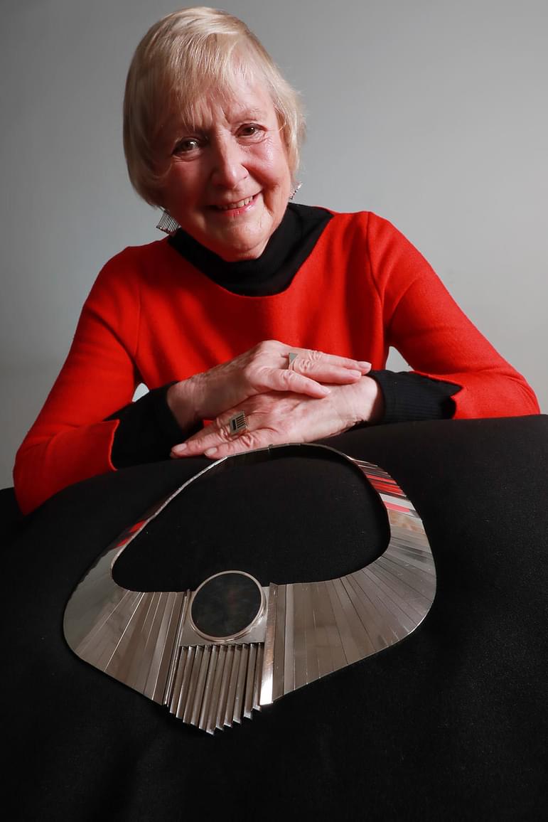 Dorothy Hogg behind a display of her articulated necklace.