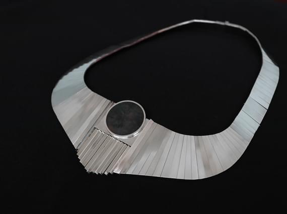 Silver link necklace with an oval stone.