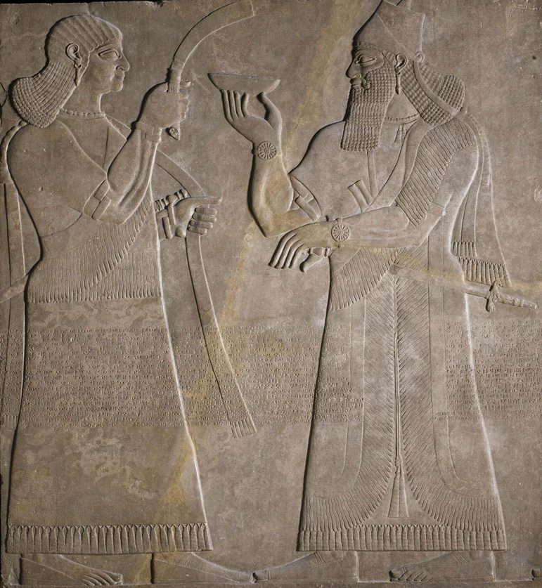 Stone panel depicting two human figures facing each other.