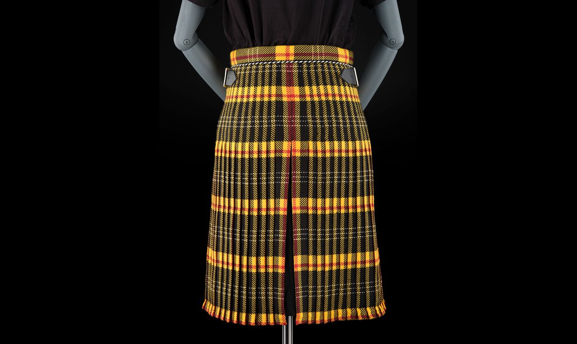 A mannequin wearing a yellow and black tartan kilt