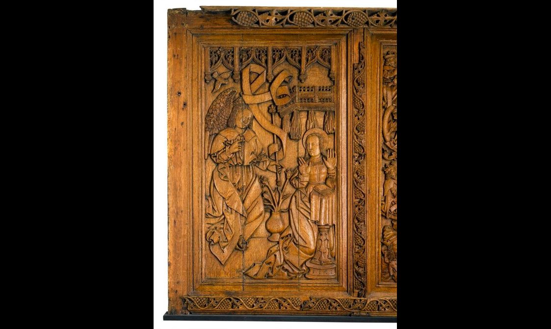 Carved oak panel showing the annunciation.
