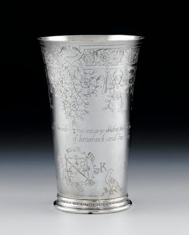 A silver communion beaker with carved decoration.
