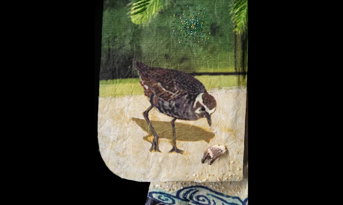 Kimono detail featuring beads, shells and a crab claw.