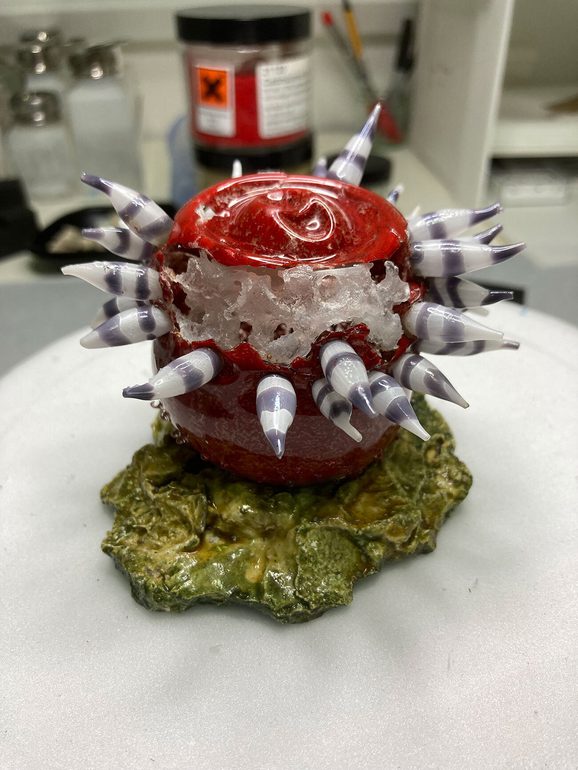 A glass model of a sea anemone now stands in once piece with support from a clear epoxy resin