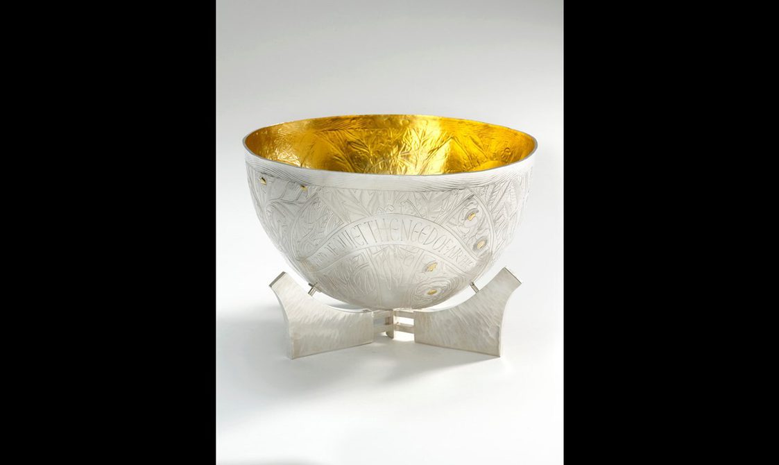 A silver bowl with a gold interior.