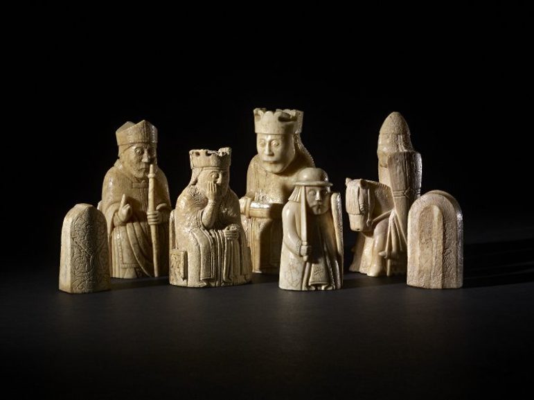 A group of seven ivory chess pieces of medieval style knights and royalty