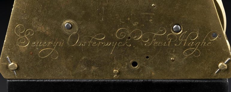 A gold plaque with the name Severyn Oosterwijck inscribed in a handwriting script.