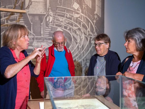 A group of visitors on a BSL tour of an exhibition space