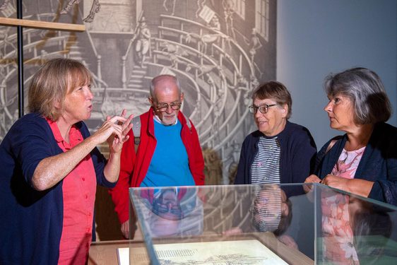 A group of visitors on a BSL tour of an exhibition space