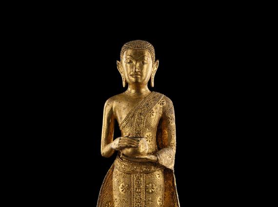 A Buddha sculpture holding an alms bowl.