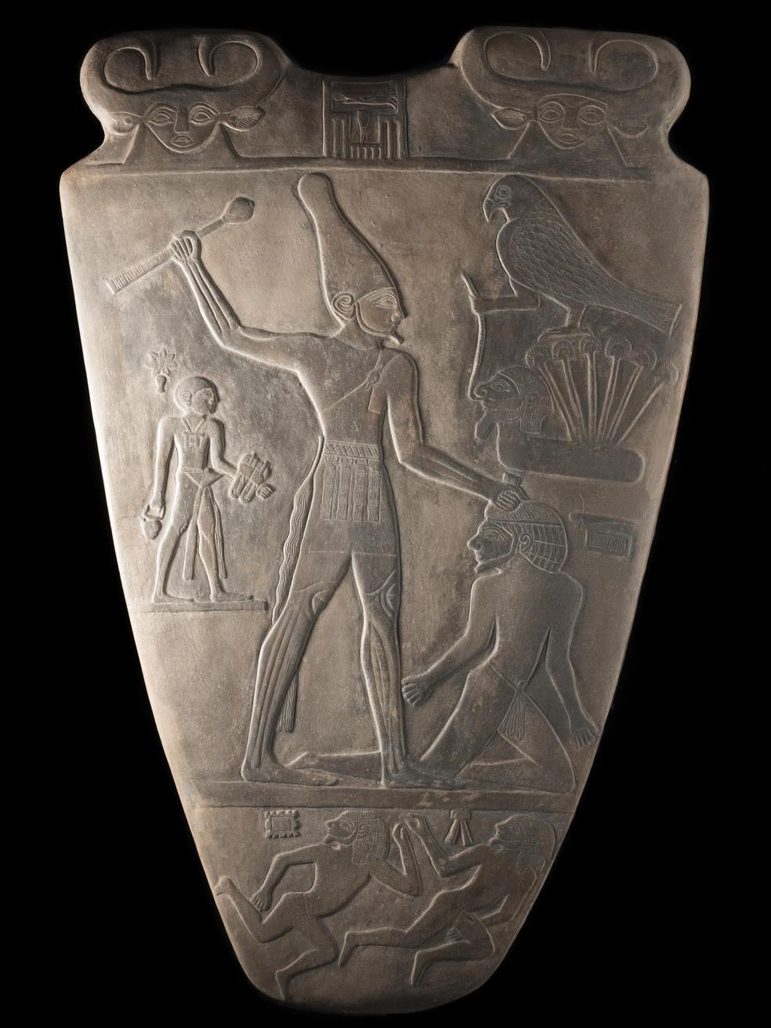 A large stone like object carved with an ancient Egyptian illustration.