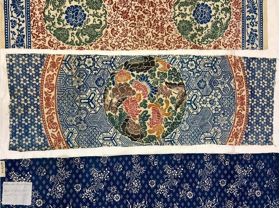 Three samples of colourful cotton cloths arranged horizontally. Each cloth has a different design common to cotton manufacturing in China.