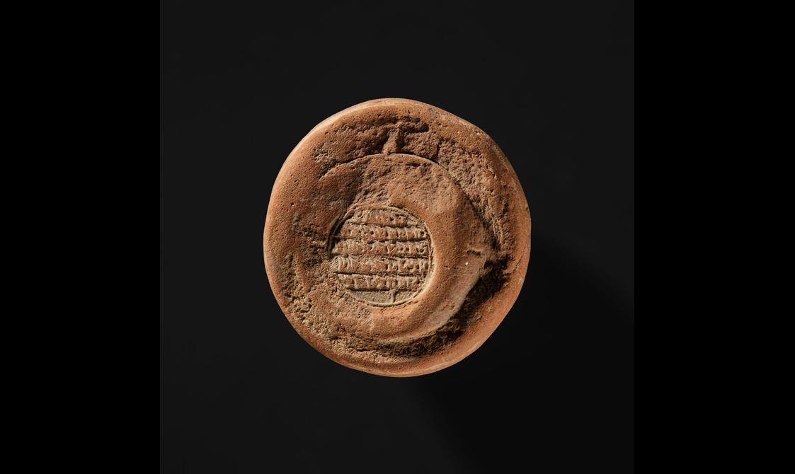 A small circular clay stūpa.