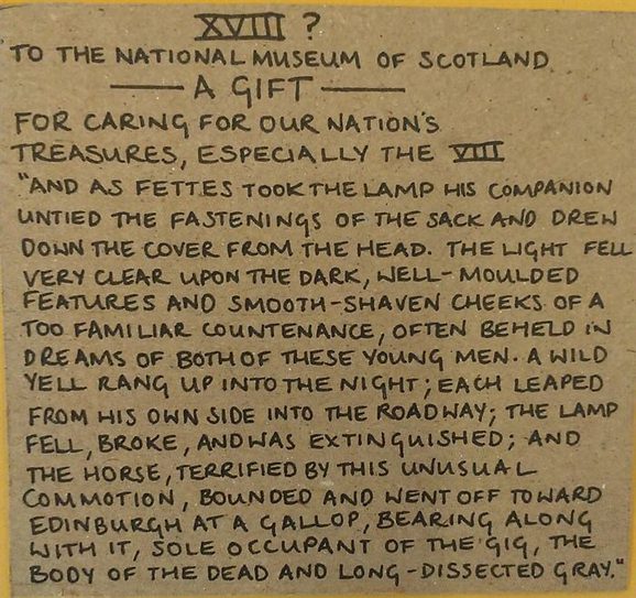 A handwritten label. The label starts with 'XVIII To the National Museum of Scotland - A gift - for caring for our nation's treasures, especially the VIII.' It then goes on to quote The Body Snatcher novel.