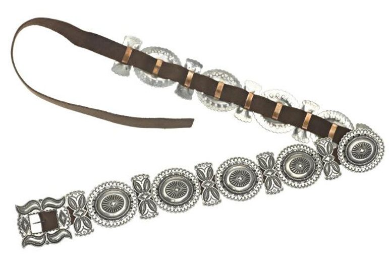 A belt made up of decorative silver disks fixed onto brown leather