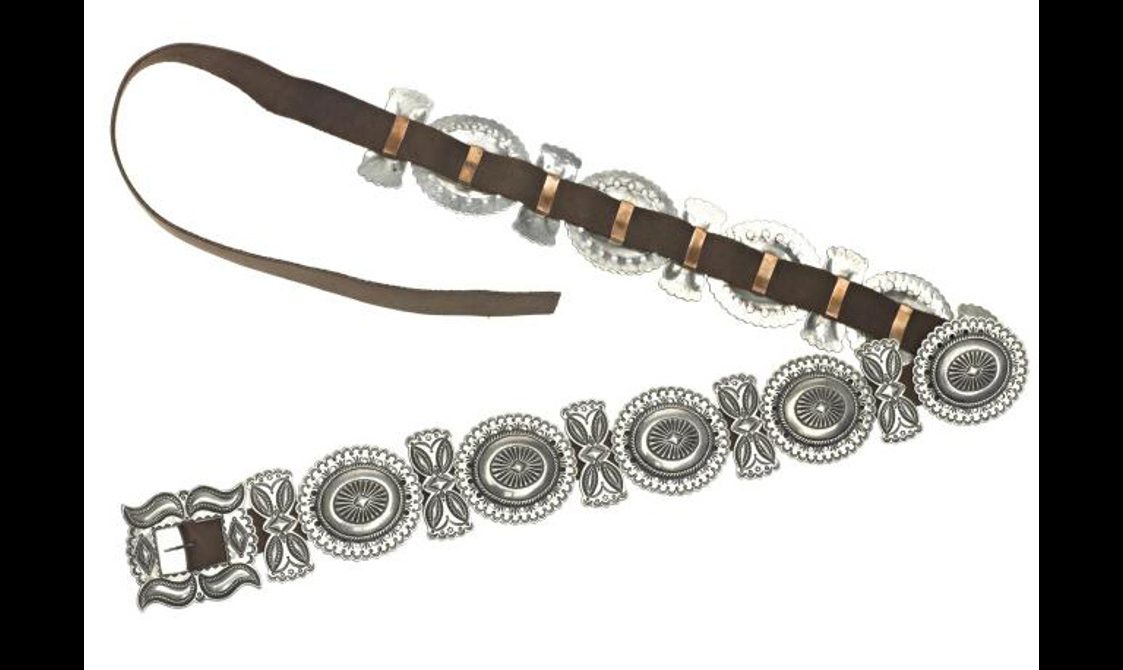 A belt made up of decorative silver disks fixed onto brown leather