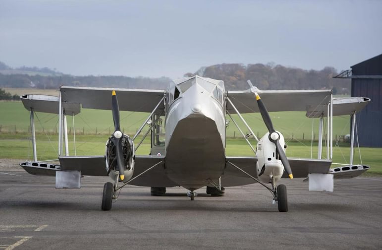 Front view of a de Havilland Dragon aircraft on a runway.