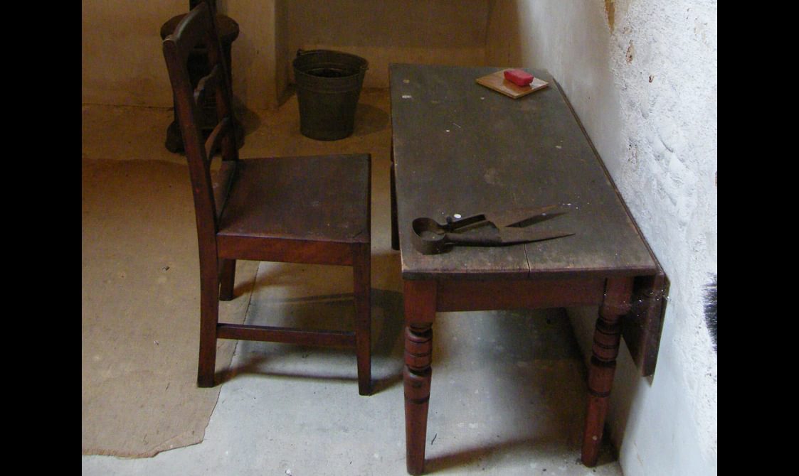 A dark brown wooden chair and desk.