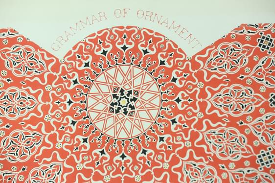 Decorative book page with a red pattern and "Grammar of Ornament" in red lettering.
