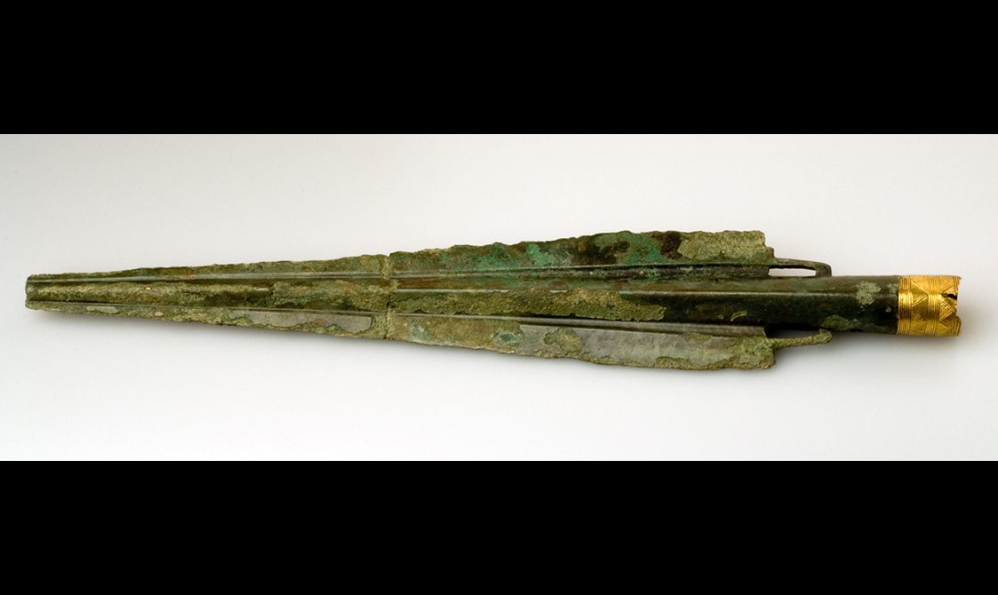 A bronze spearhead with a decorated gold collar