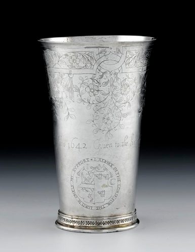 A silver communion beaker with carved decoration.