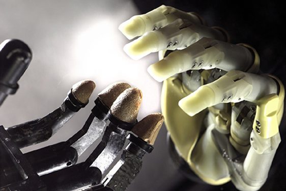 A colour photograph of two prosthetic hands. Both are made of an artificial material and have individual joints for each digit.