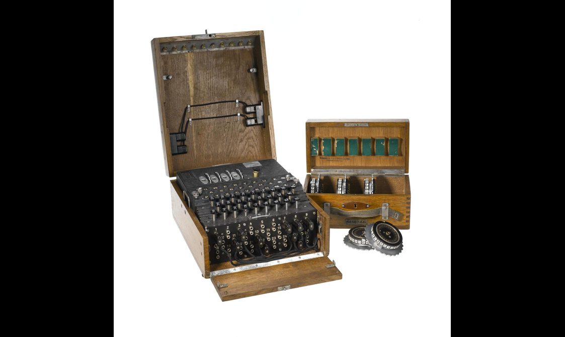 'Enigma' encoding machine in wooden case with four code rotors, and a wooden case containing five spare rotors.
