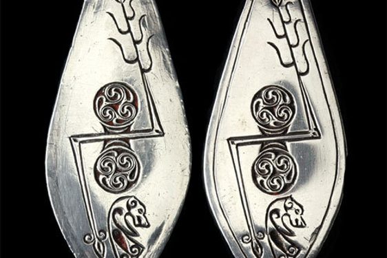 Leaf-shaped plaques of silver designed with Pictish symbols.